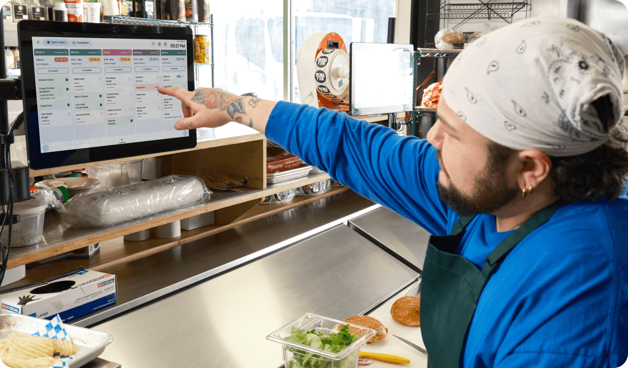 Cooks using SpotOn KDS in a kitchen of a casual dining restaurant