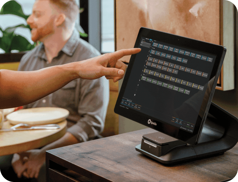 Server using SpotOn RPOS on Station 15 in a casual dining restaurant