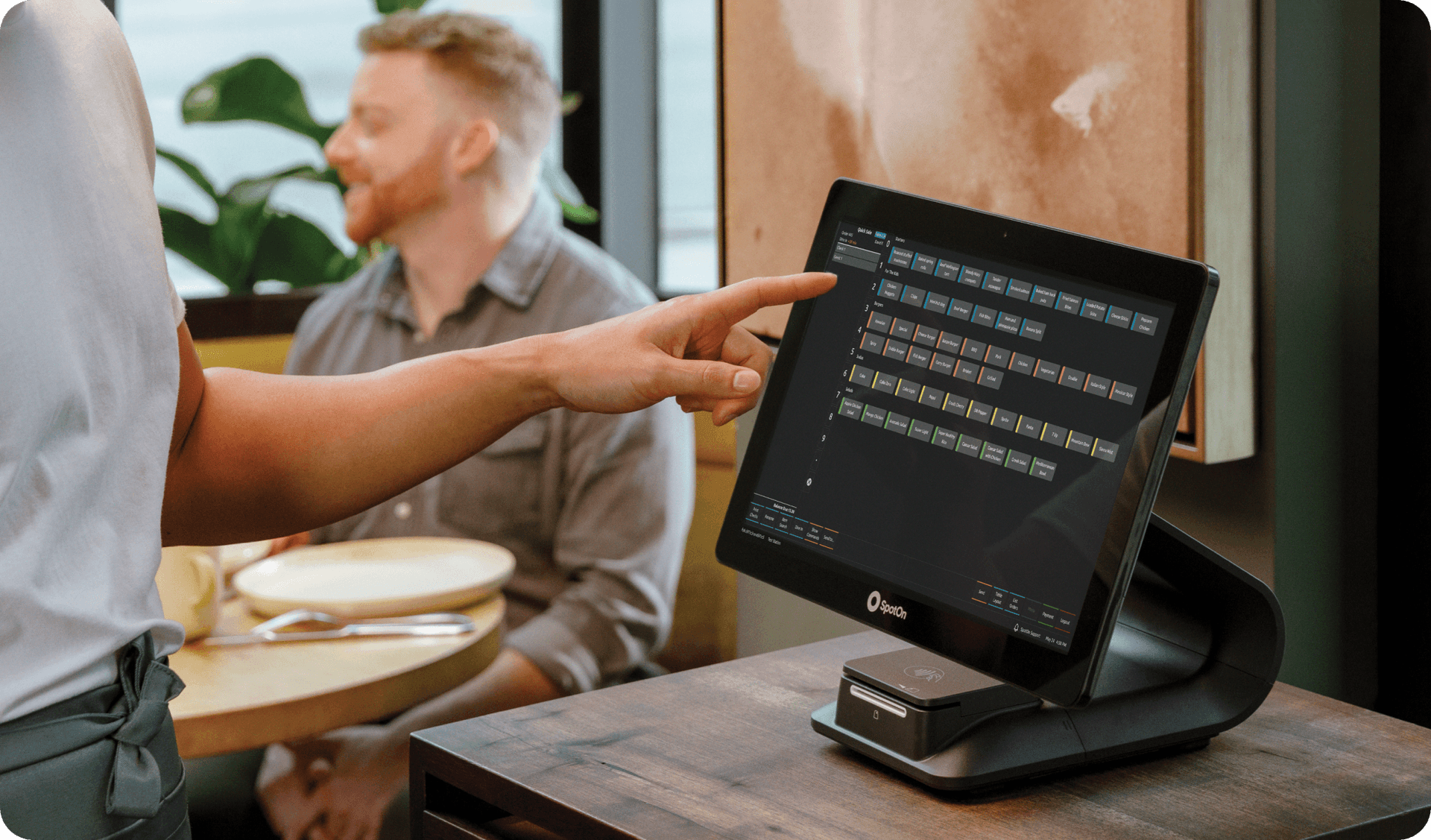 Server using SpotOn RPOS on Station 15 in a casual dining restaurant