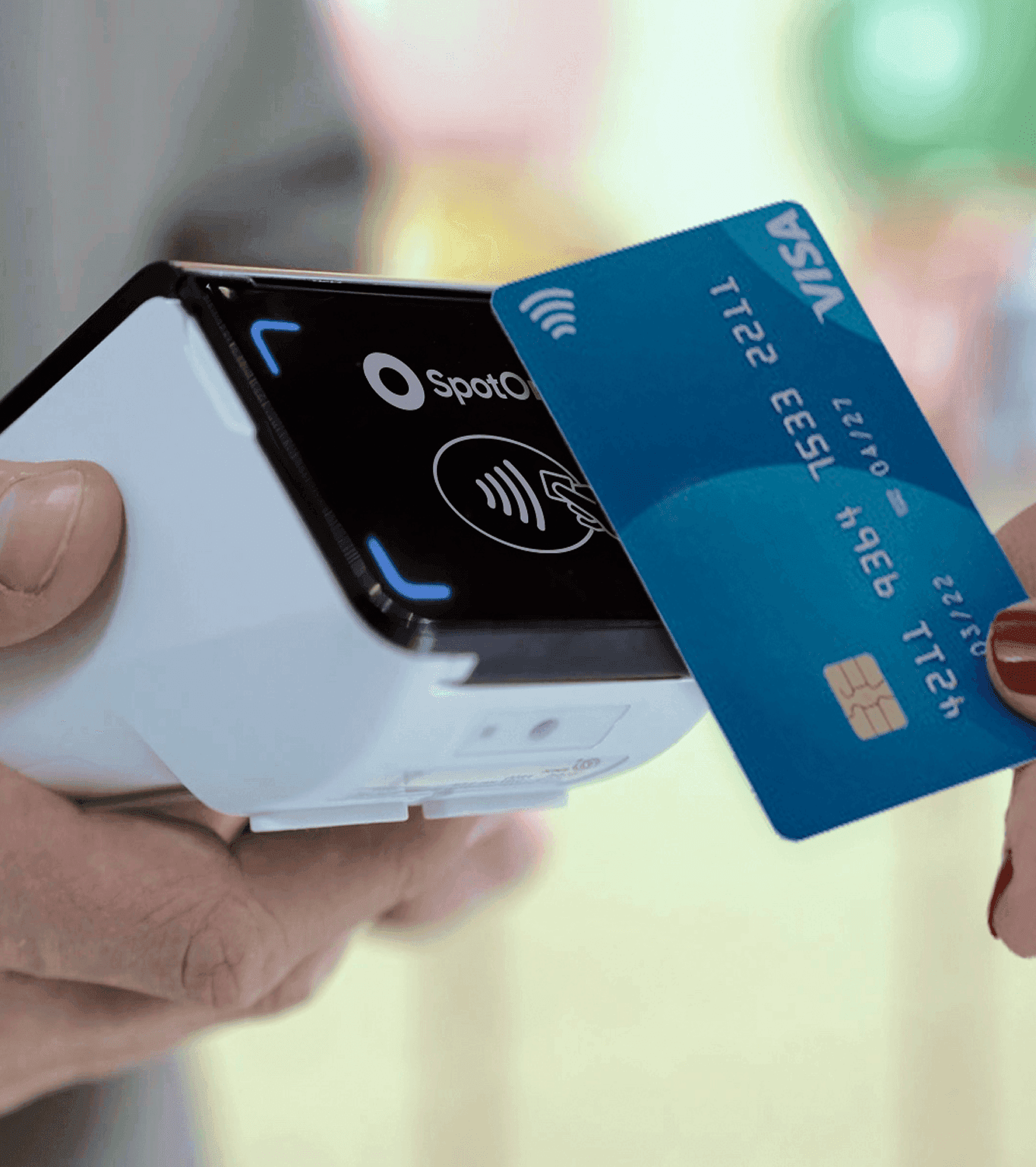 A small business owner takes a card payment from a customer