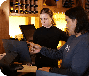 SpotOn employee unpacking SpotOn POS equipment at the bar
