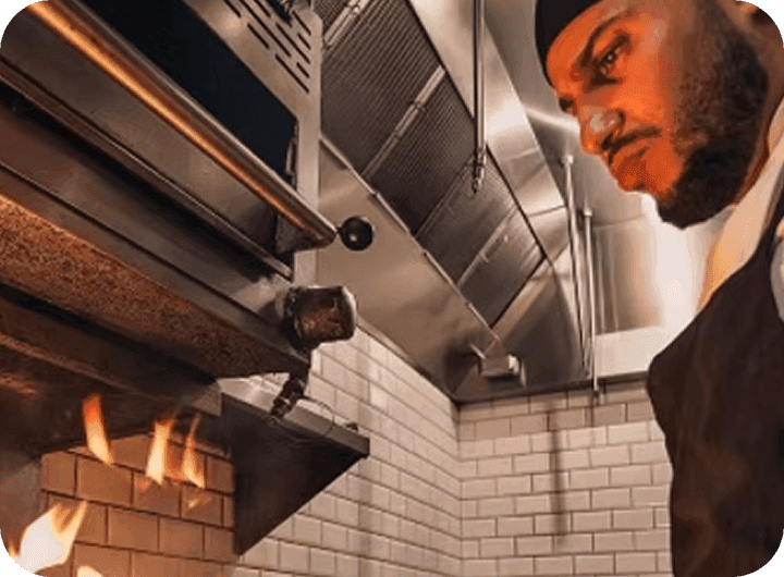 Chef and Uptown 66 cofounder Nuno Grullon fires a dish in the restaurant kitchen