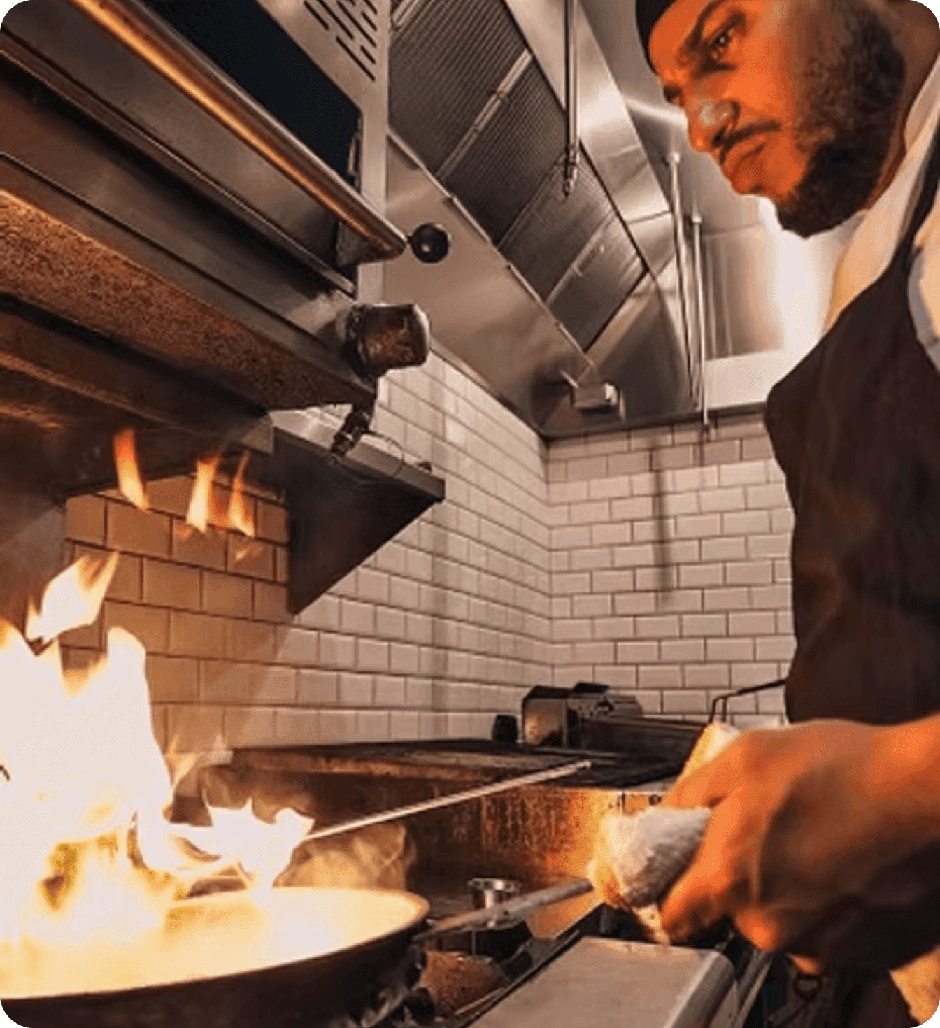 Chef and Uptown 66 cofounder Nuno Grullon fires a dish in the restaurant kitchen