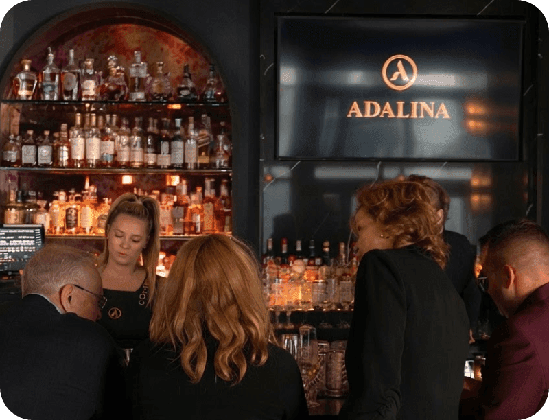 Guests at the bar at Adalina restaurant
