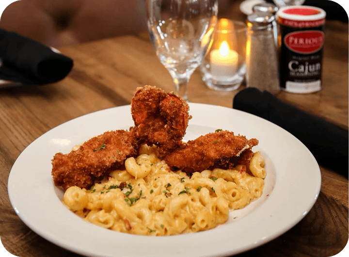 Fried seafood over crawfish mac and cheese with Perioux’s Cajun Seasoning at Pat’s of Henderson