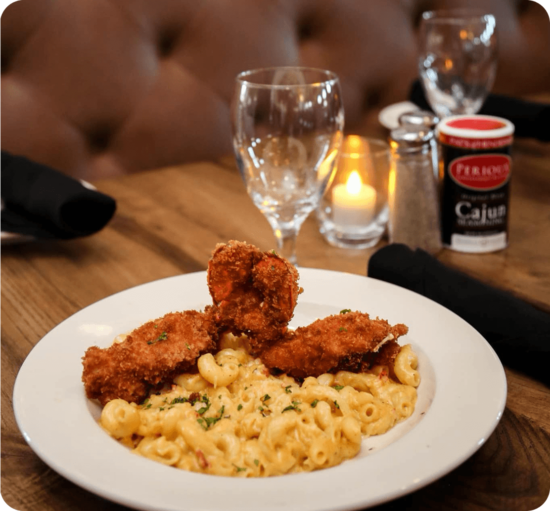 Fried seafood over crawfish mac and cheese with Perioux’s Cajun Seasoning at Pat’s of Henderson