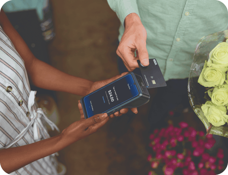 A small business employee runs a payment on a POS terminal