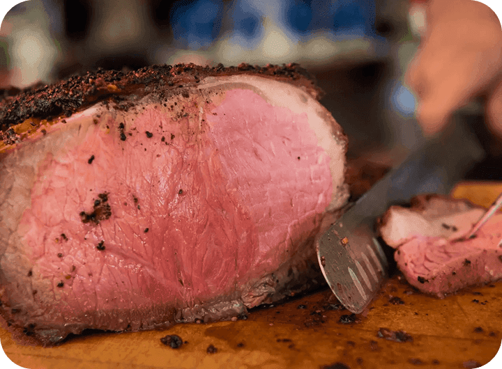 A peppercorn-crusted prime rib being carved at DeBlaze at 131