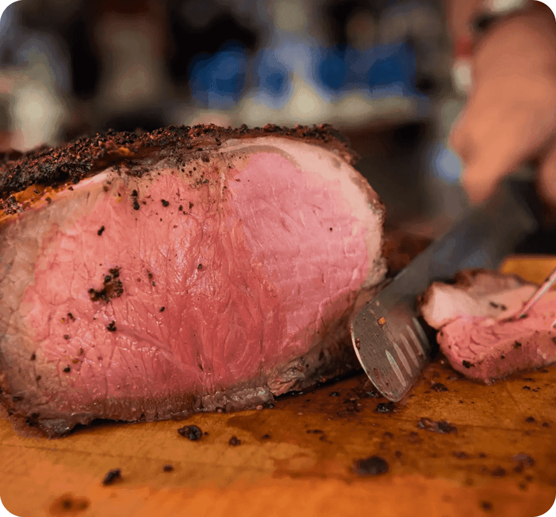 A peppercorn-crusted prime rib being carved at DeBlaze at 131