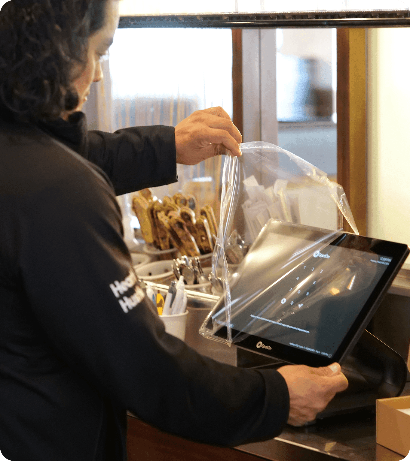 SpotOn technician installing POS hardware in a restaurant