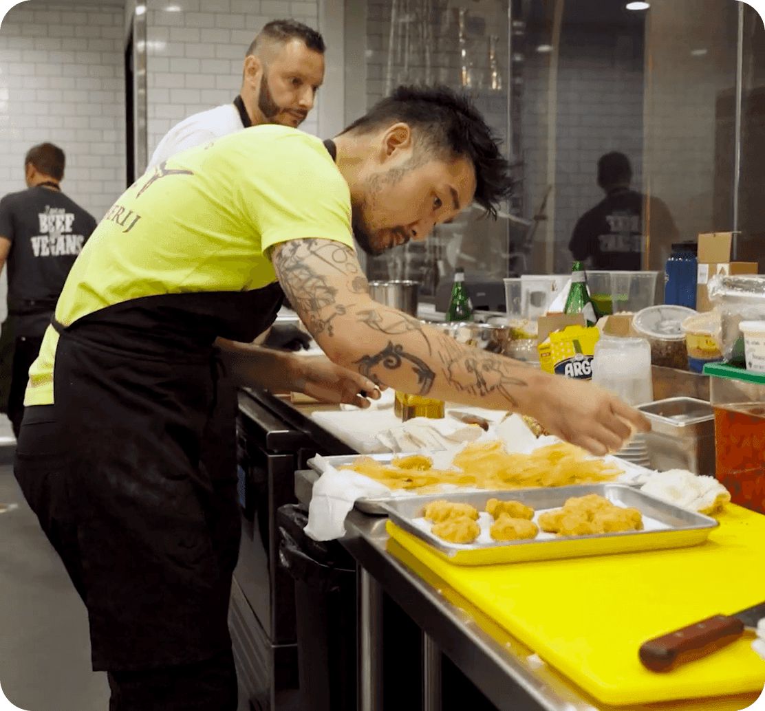 Soo Ahn, Chef & Partner of Adalina Prime, plating fried dishes in the kitchen