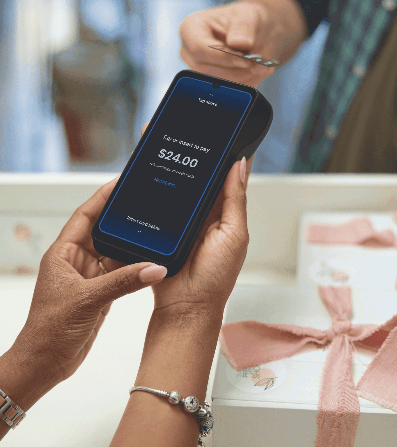 A small business owner takes a card payment from a customer
