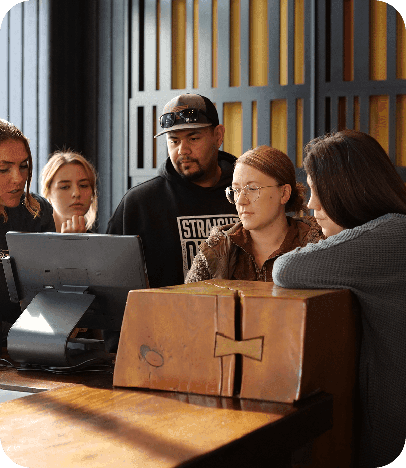 SpotOn’s local Hawaii team gathered around a restaurant POS station