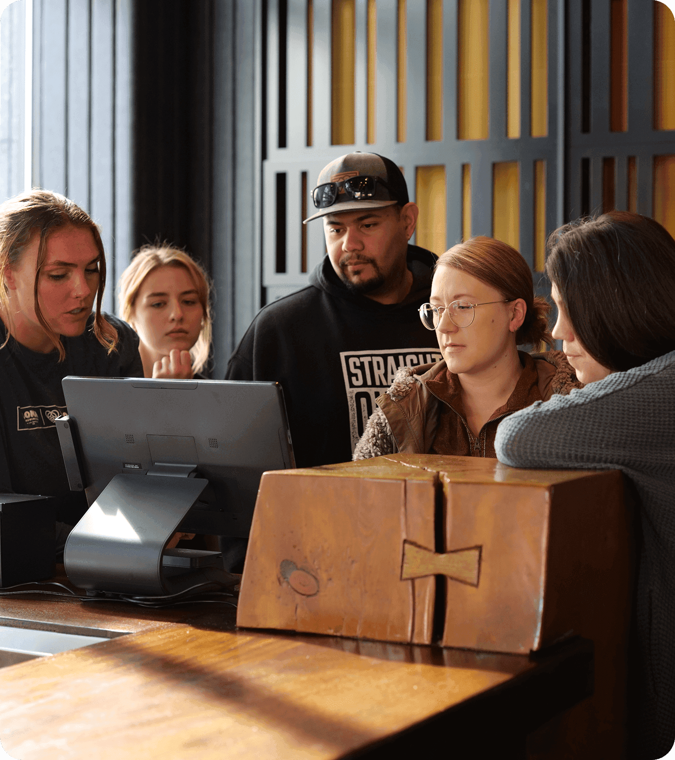 SpotOn’s local Hawaii team gathered around a restaurant POS station