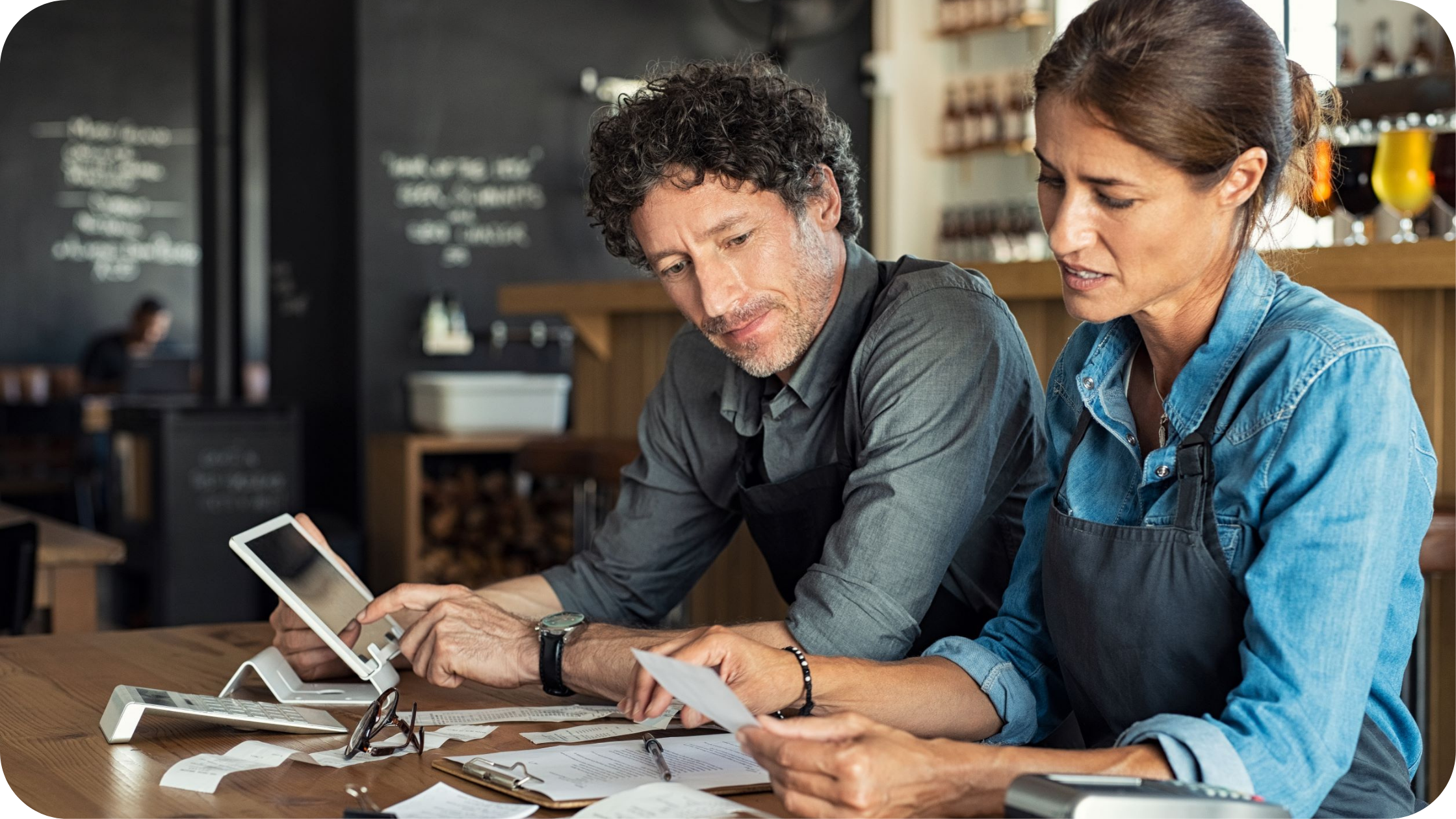 Restaurant owners calculating their profit margins.