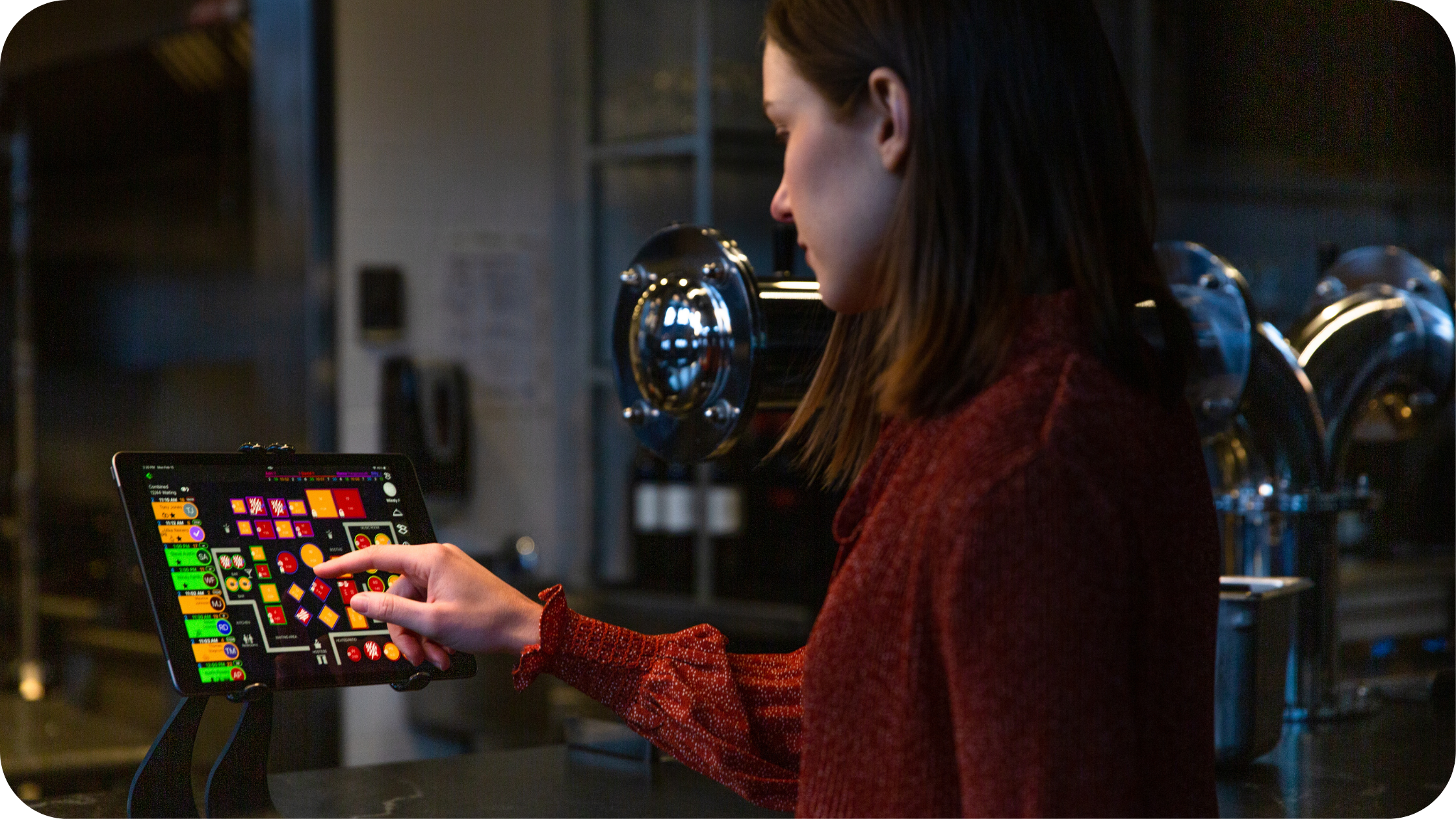 Restaurant staff member viewing waitlist and seating map on SpotOn Reserve.