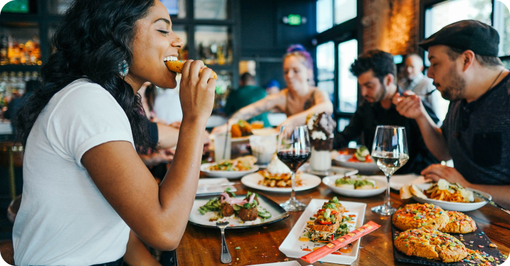 Guests eating Mediterranean food at a trendy casual restaurant.