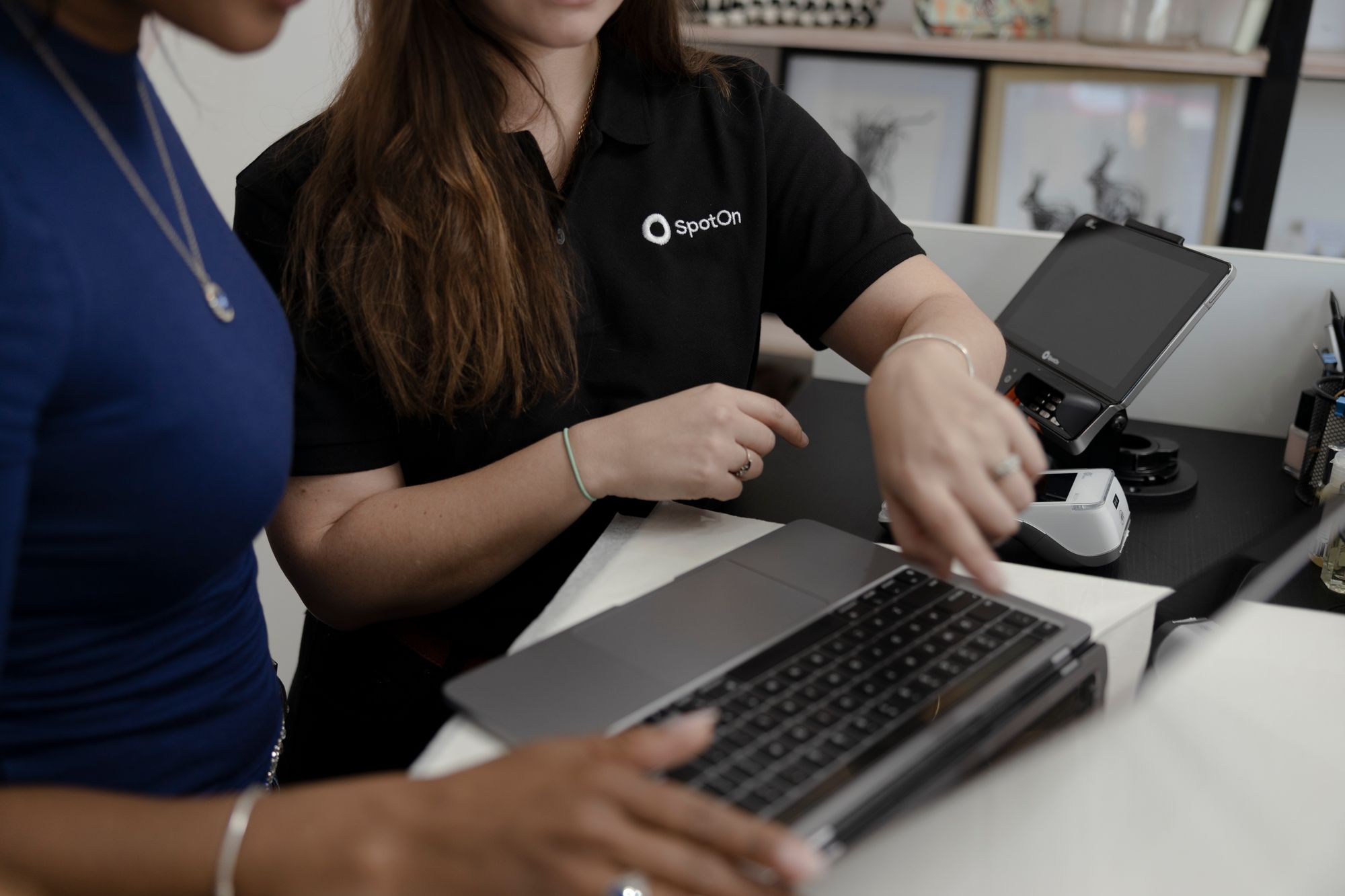 A local SpotOn Executive helps a retail owner set up their online store.