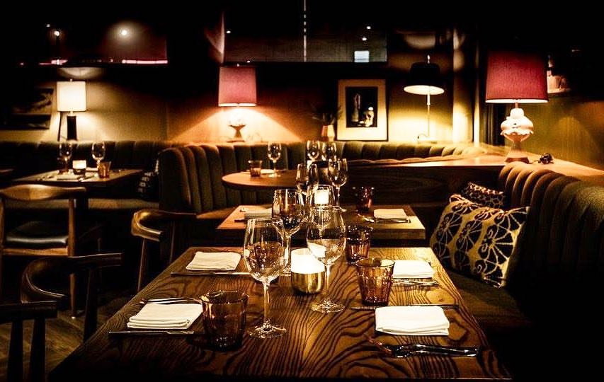 A warmly lit, welcoming restaurant dining room