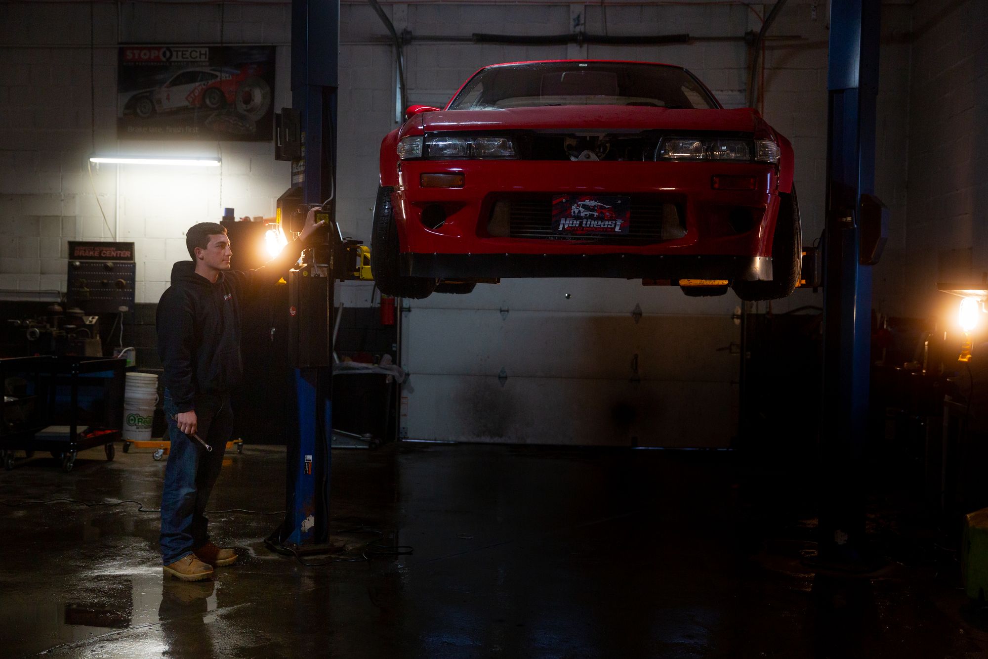 Derek Griffith working on a car at Northeast Auto Imports