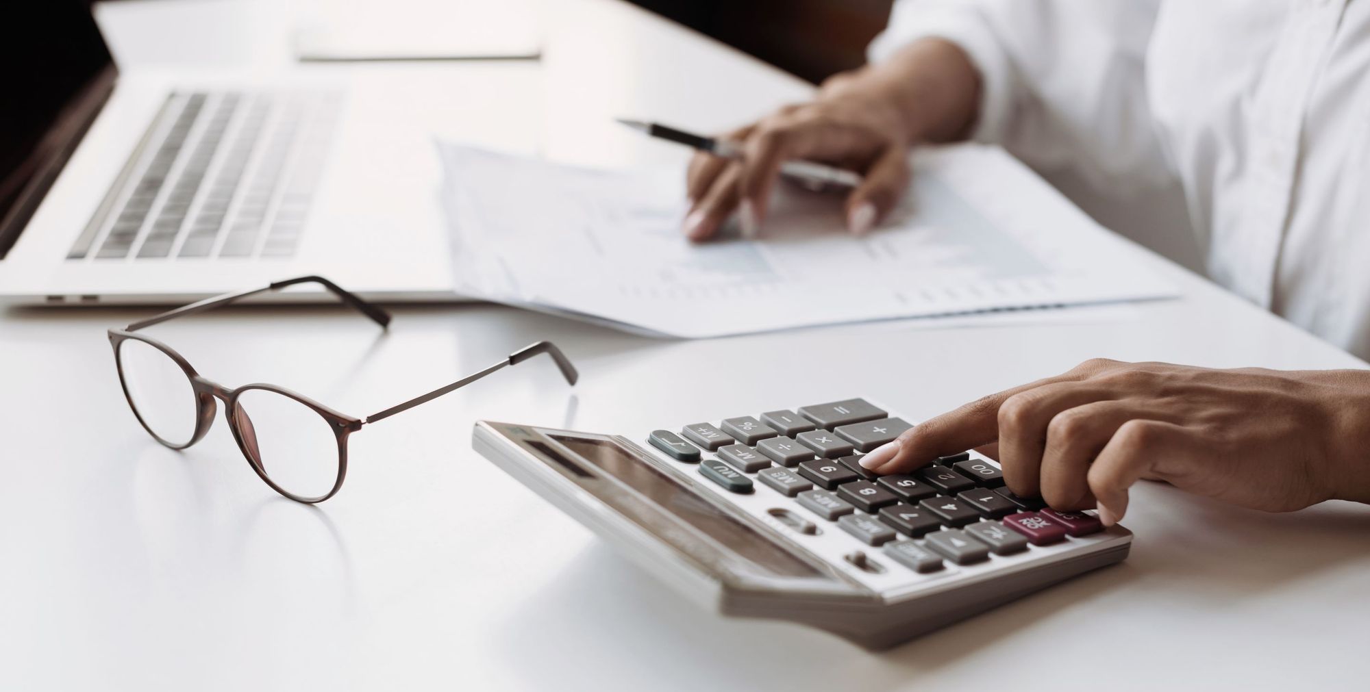 A restaurant manager types numbers into a calculator