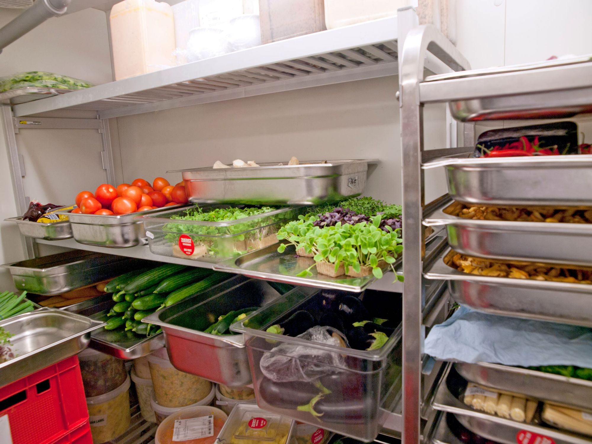 A walk-in refrigerator full of vegetables