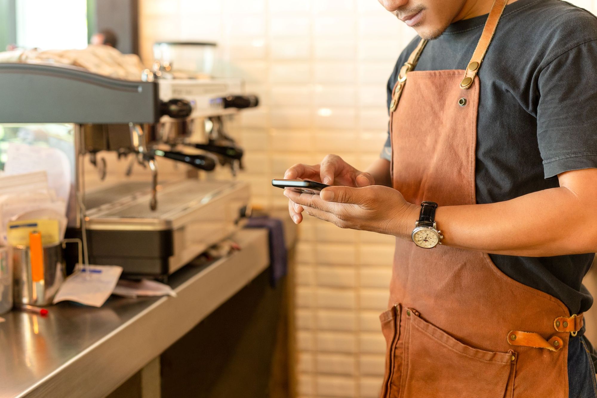 A restaurant employee requests time off from their phone using the SpotOn employee app