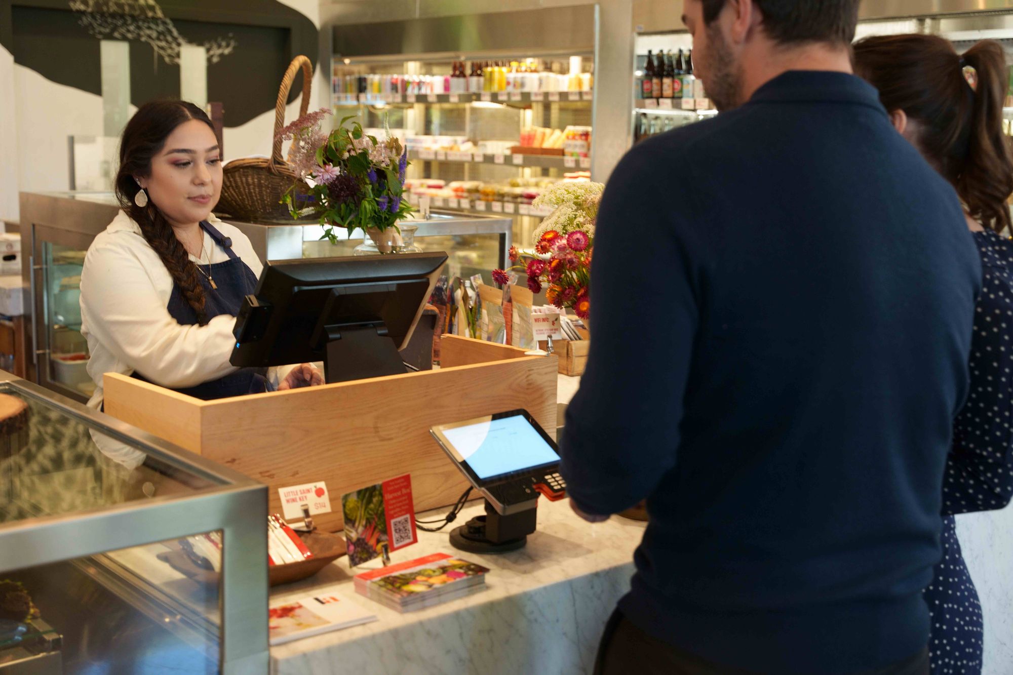 Restaurant staff ringing up guests at a poit-of-sale station.