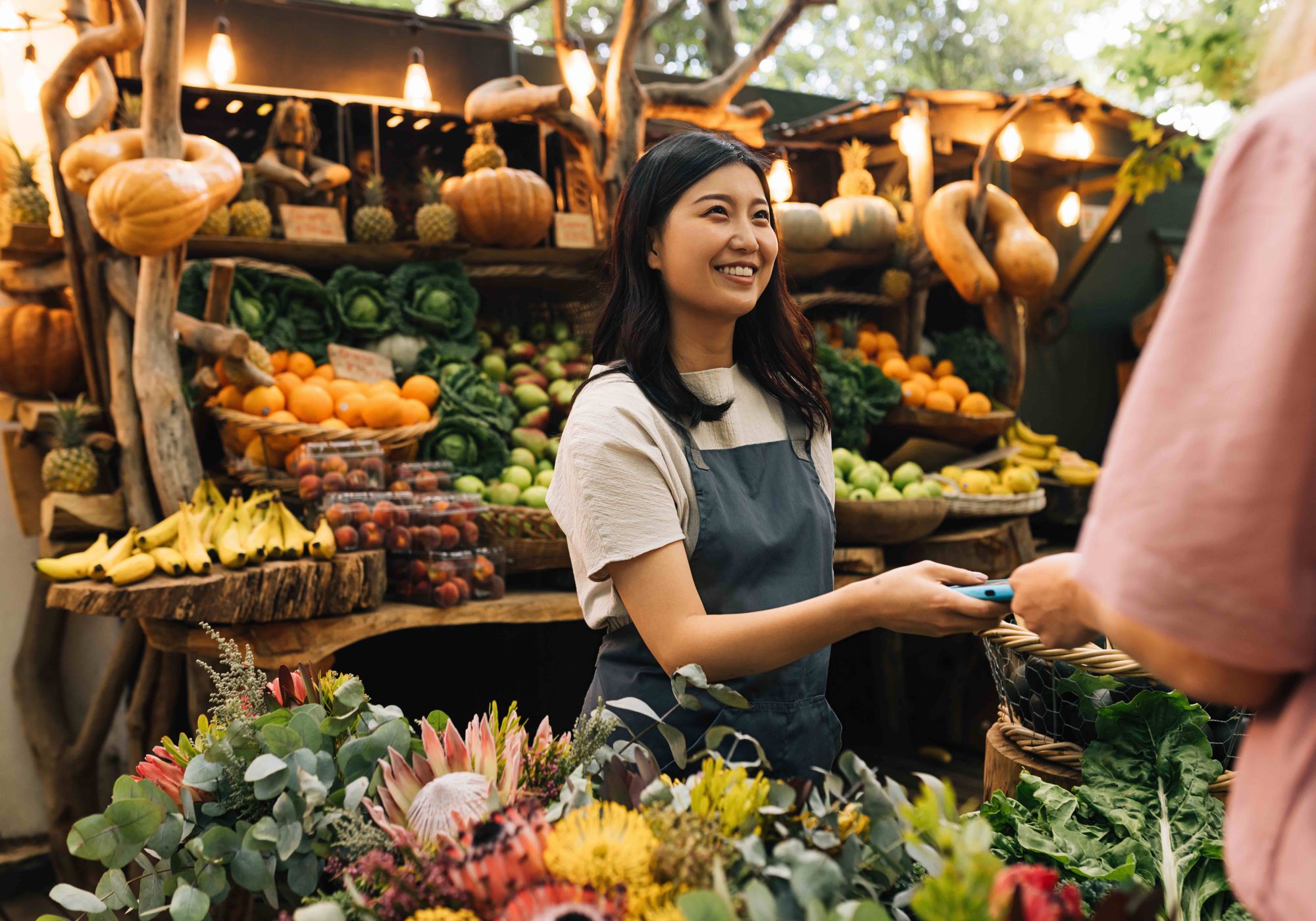 Woman receiving a payment at a local farmer's market.