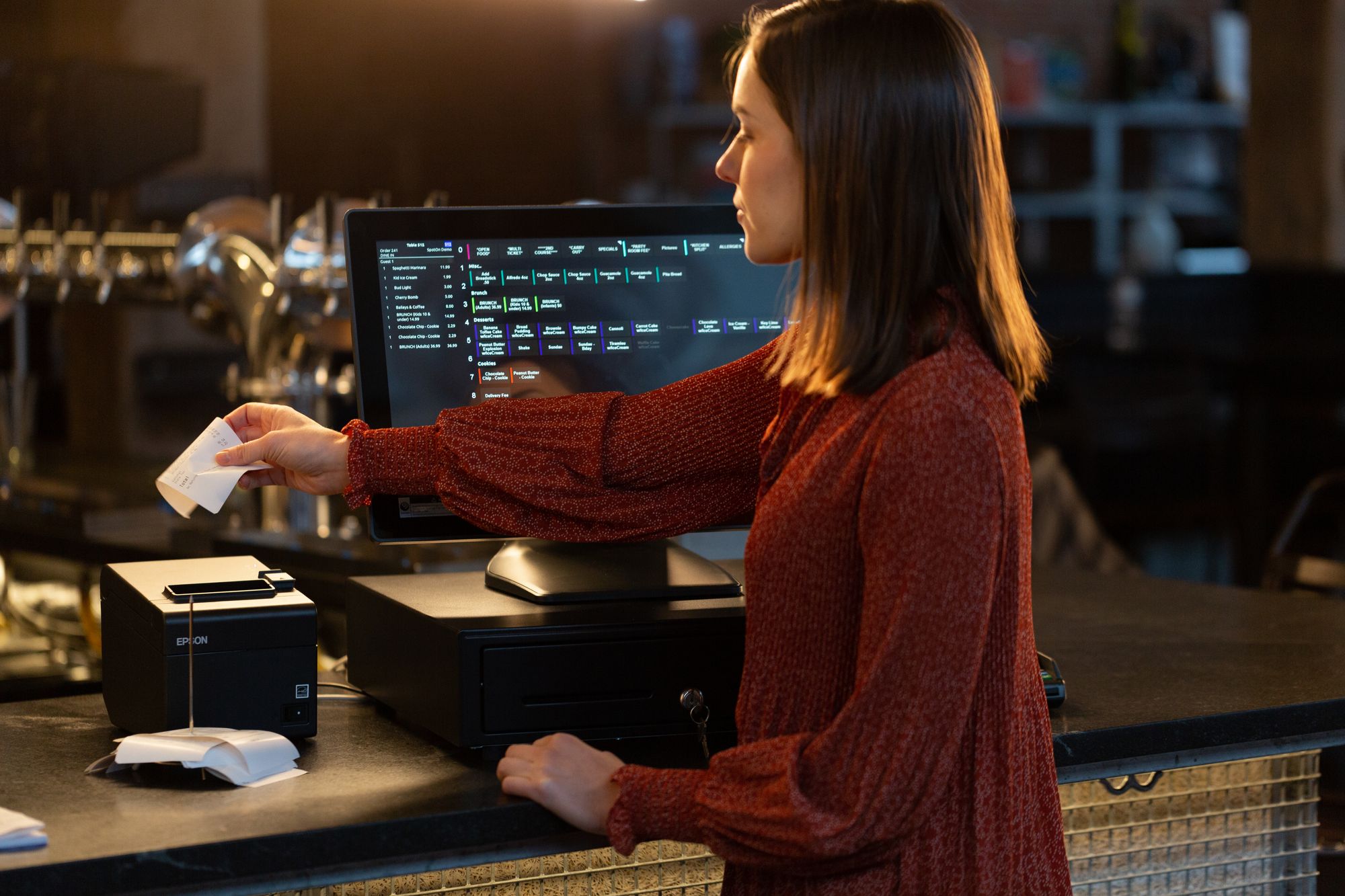 Woman working with a strong point-of-sale system to get orders