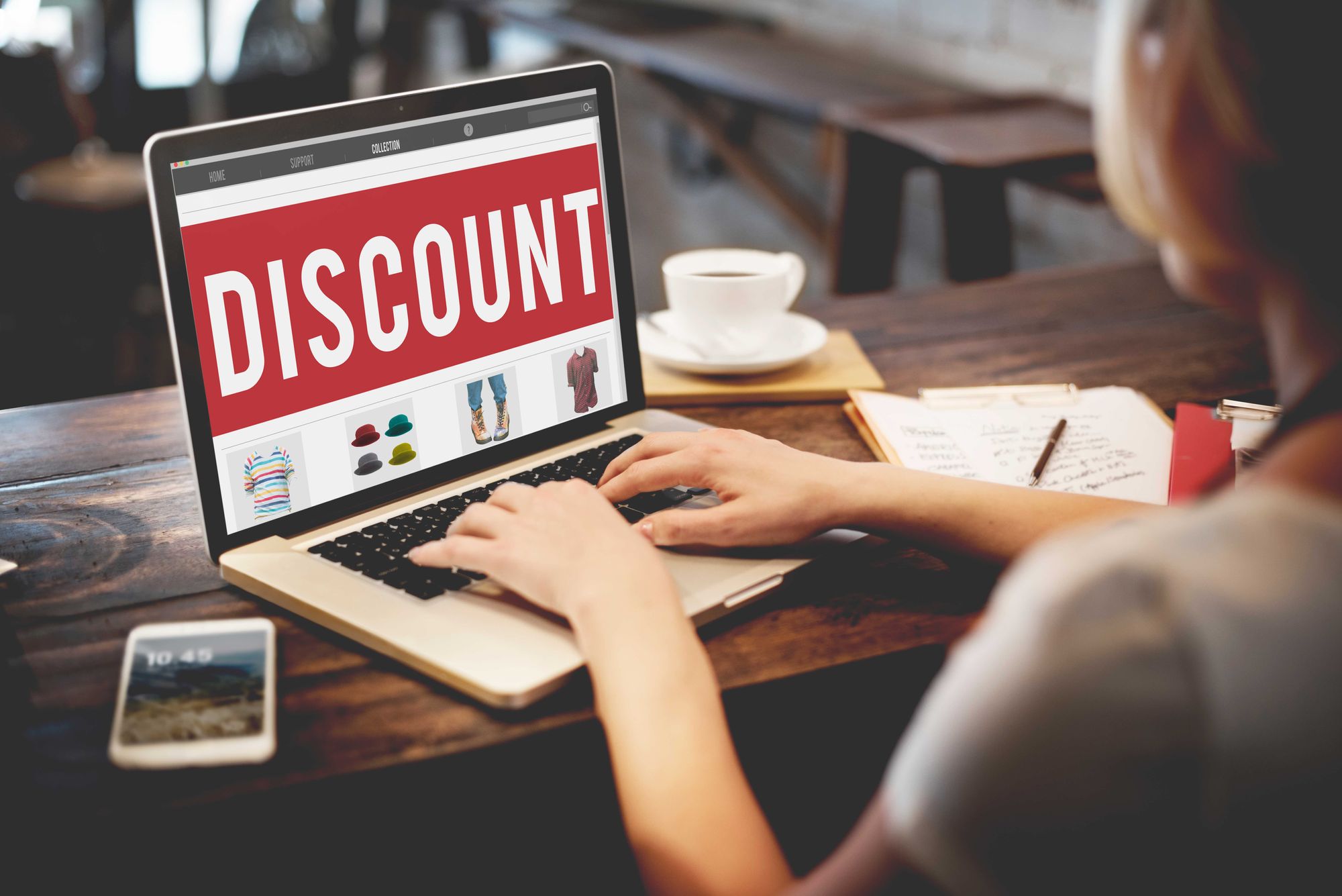 Woman at a desk with a laptop that reads "Discount" on the sceen.