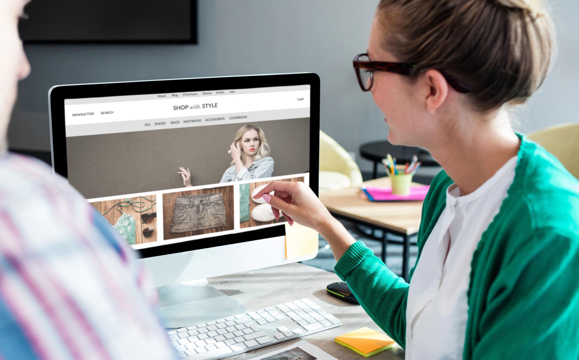 A small business owner looks over her business website on a laptop