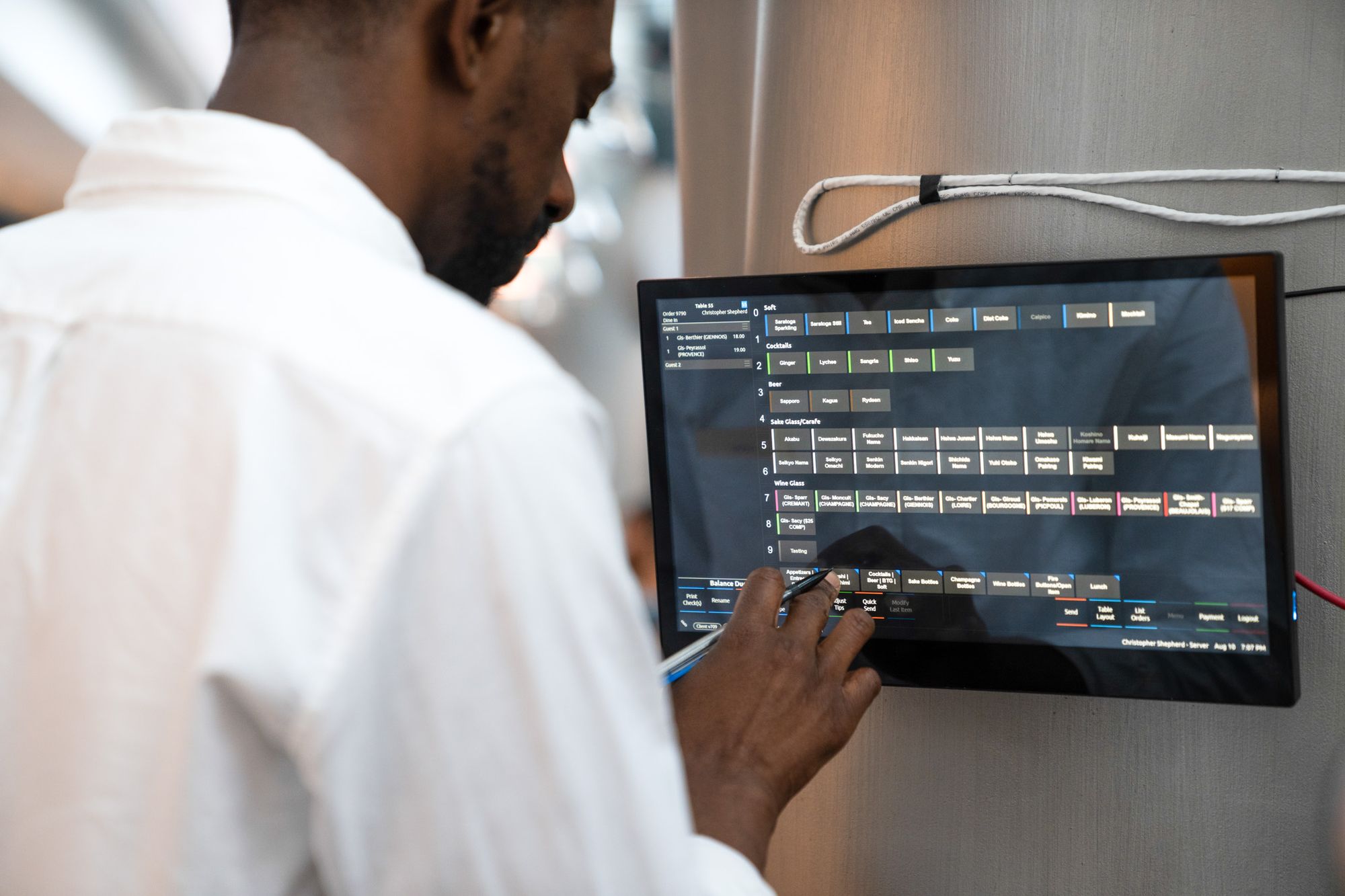 Restaurant server placing an order on the point-of-sale system.