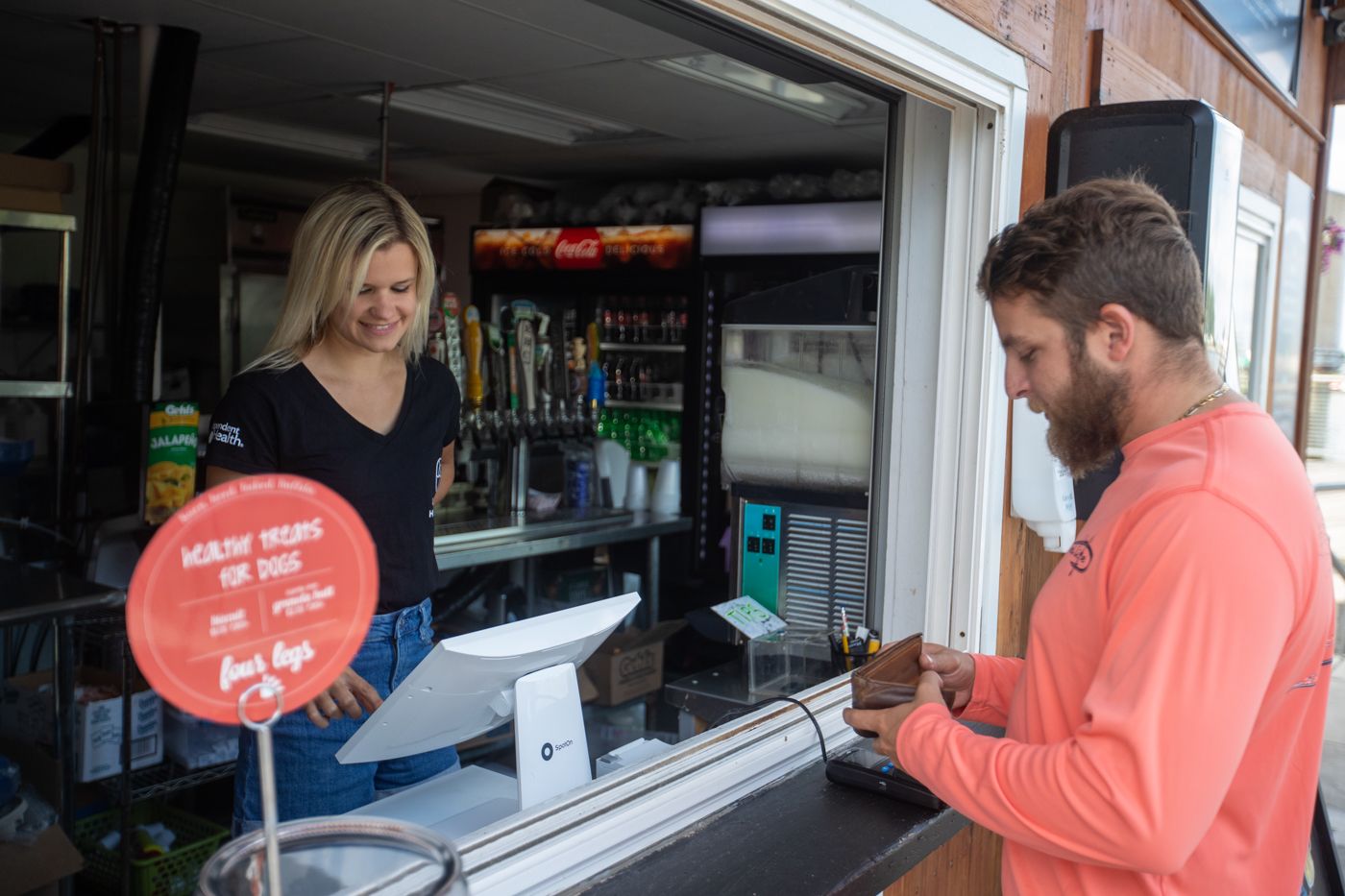 Guest paying at a SpotOn POS system for delicious food.