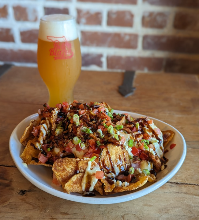 A plate of food and a glass of beer at Hell n' Blazes Brewing Company