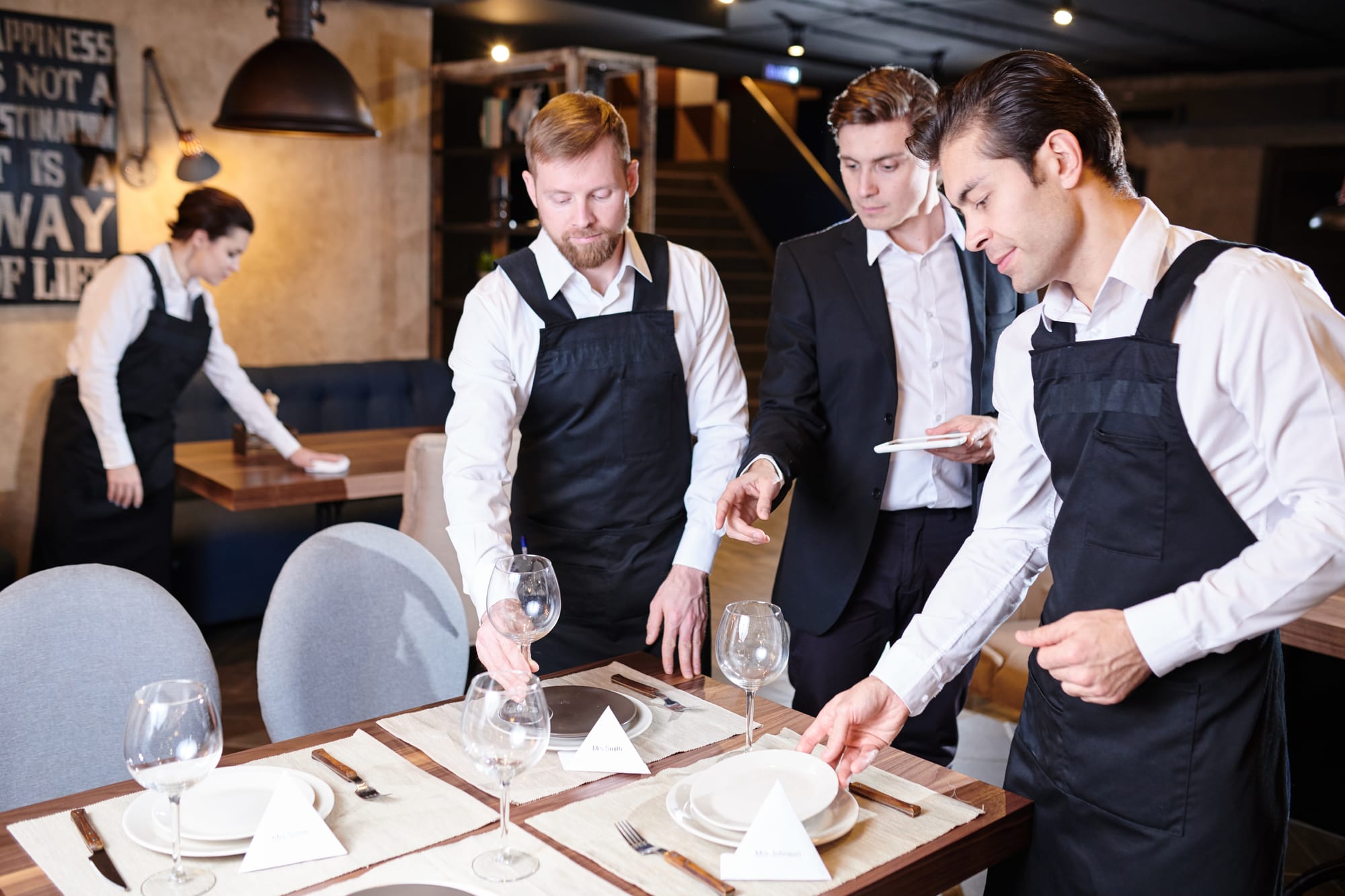 Restaurant staff setting a table.
