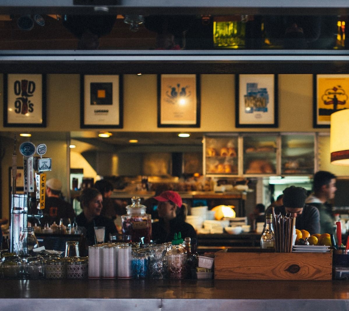 Restaurant guests sitting in a restaurant cafe bar table as servers take orders