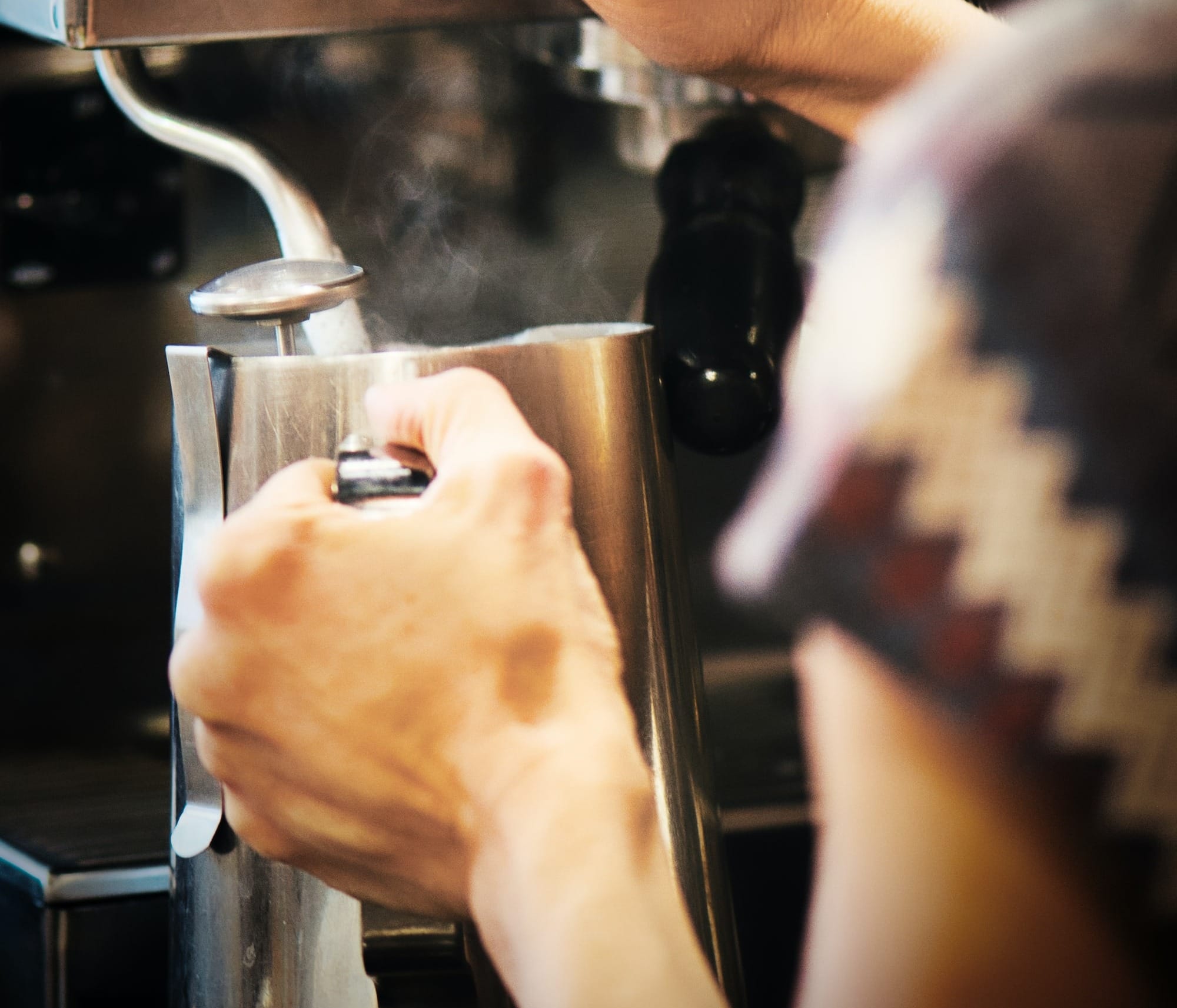 Barista making steamed milk.