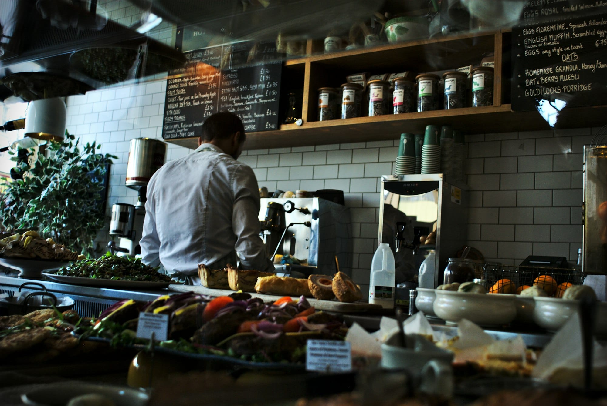 A barista making coffee at a cafe.