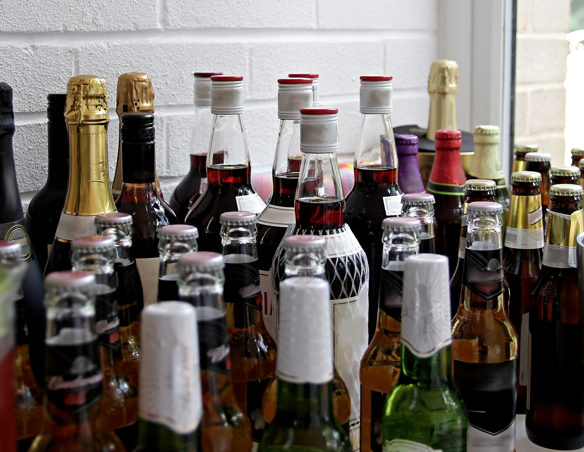 An assortment of beer, champaign, and liquor bottles.