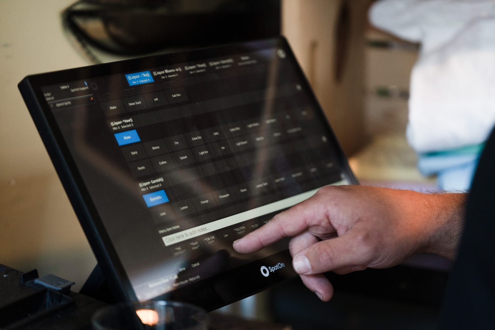 bartender going through a bar point of sale for drink orders