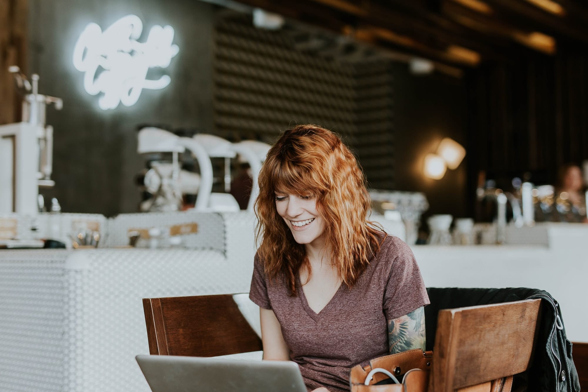 Woman on a laptop at a cafe.