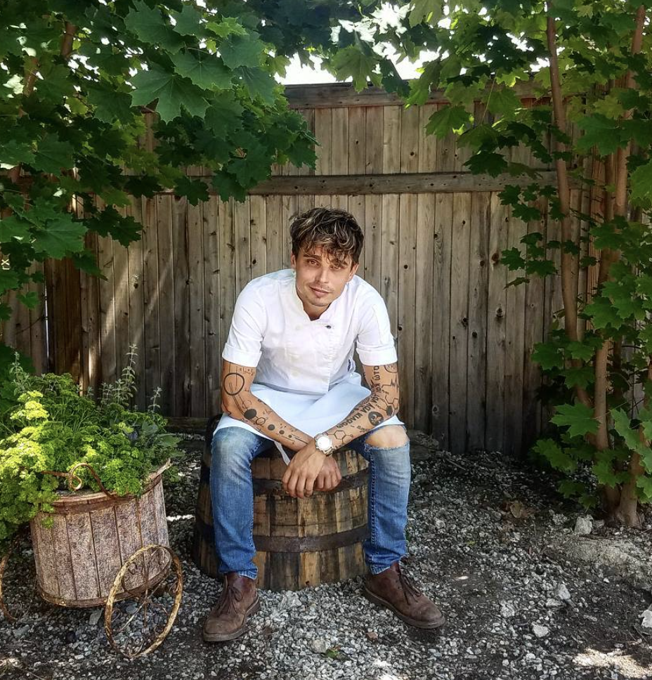 Fine dining chef sitting at a restaurant backyard with ingredients for cooking great meals.