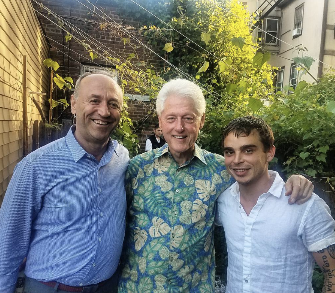 Professional fine-dining chef poses with restaurant guest and President Bill Clinton.