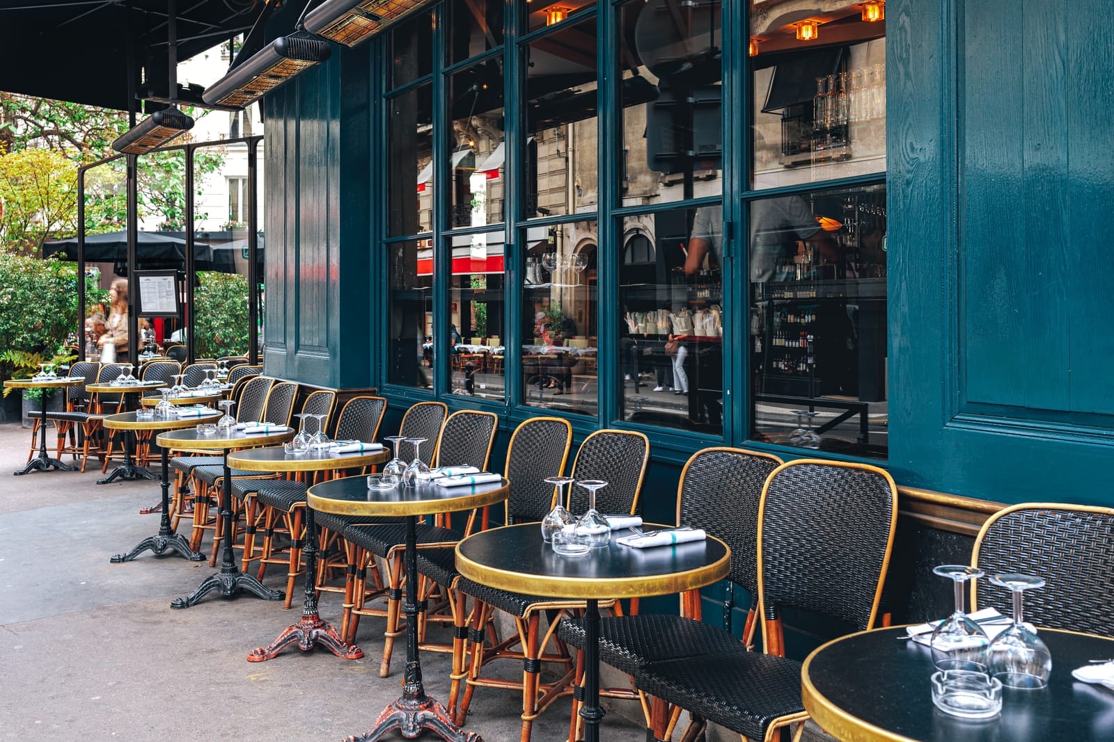 Restaurant table seating in France or Europe with glasses and prix fixe dinner menu options