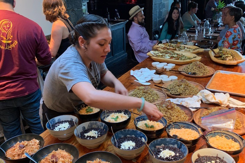 Dayana Perez preparing food for guests.