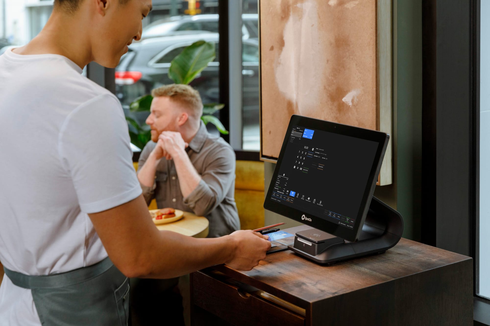 Server taking a payment on the SpotOn Restaurant POS.