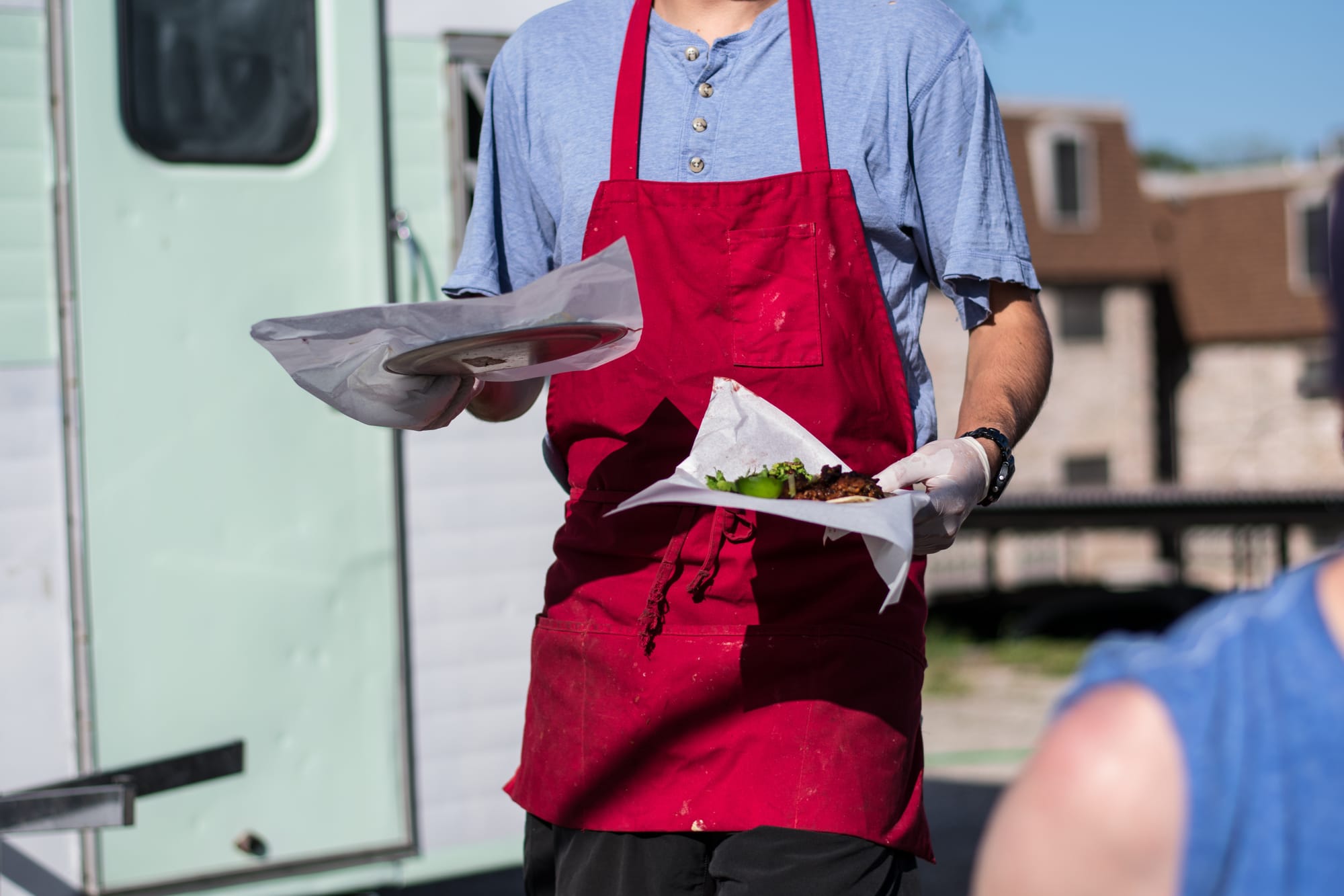 BBQ restaurant server bringing BBQ tacos Texas style to restaurant guests.