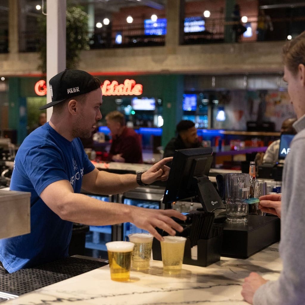 An Amory bartender processes an order at the SpotOn POS station.