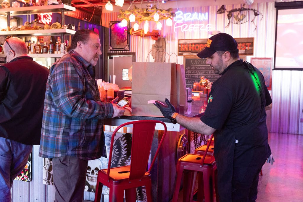 Guest picks up an online order at Chicago Culinary Kitchen.